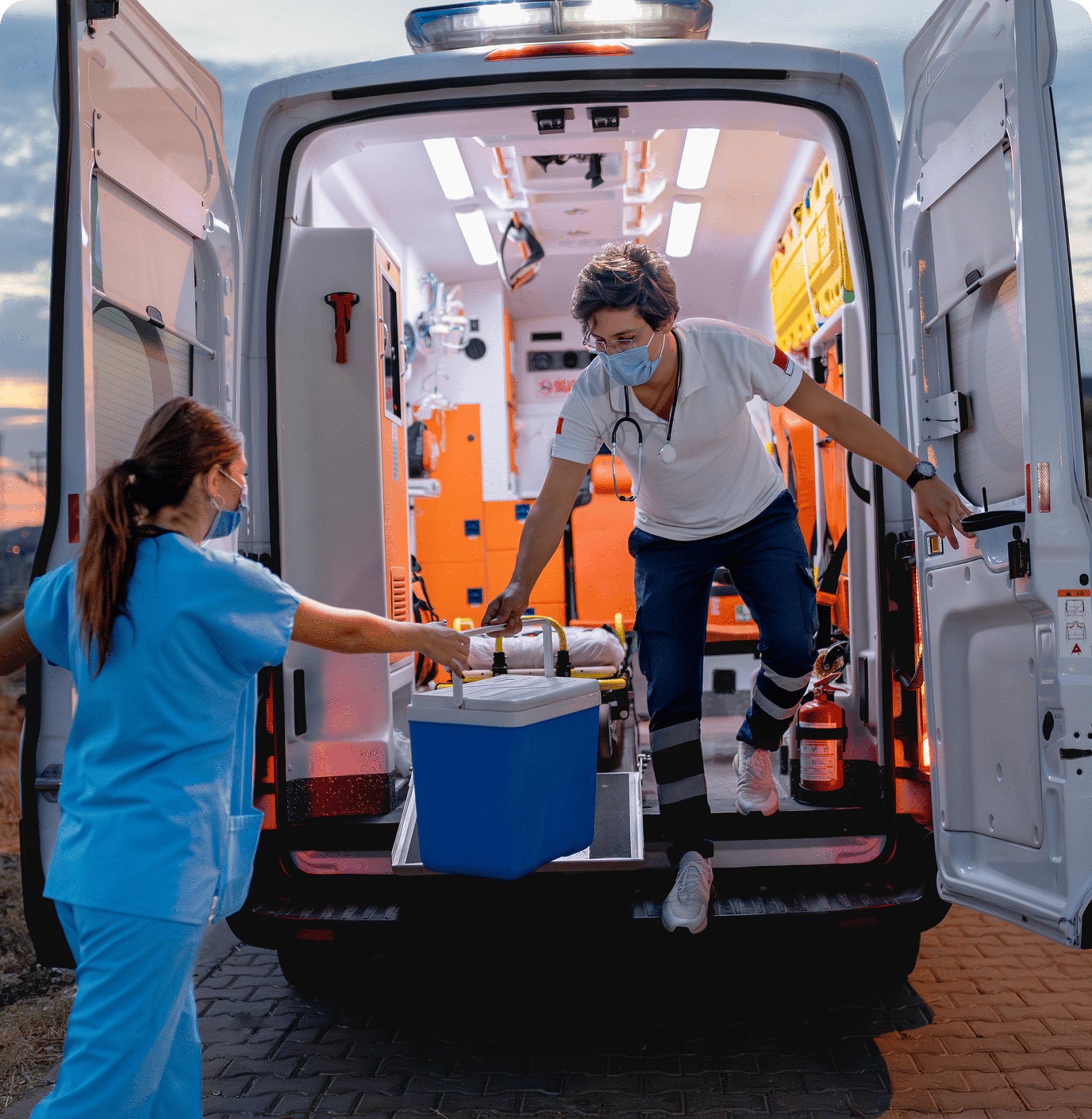 Medical professionals handling equipment from ambulance.